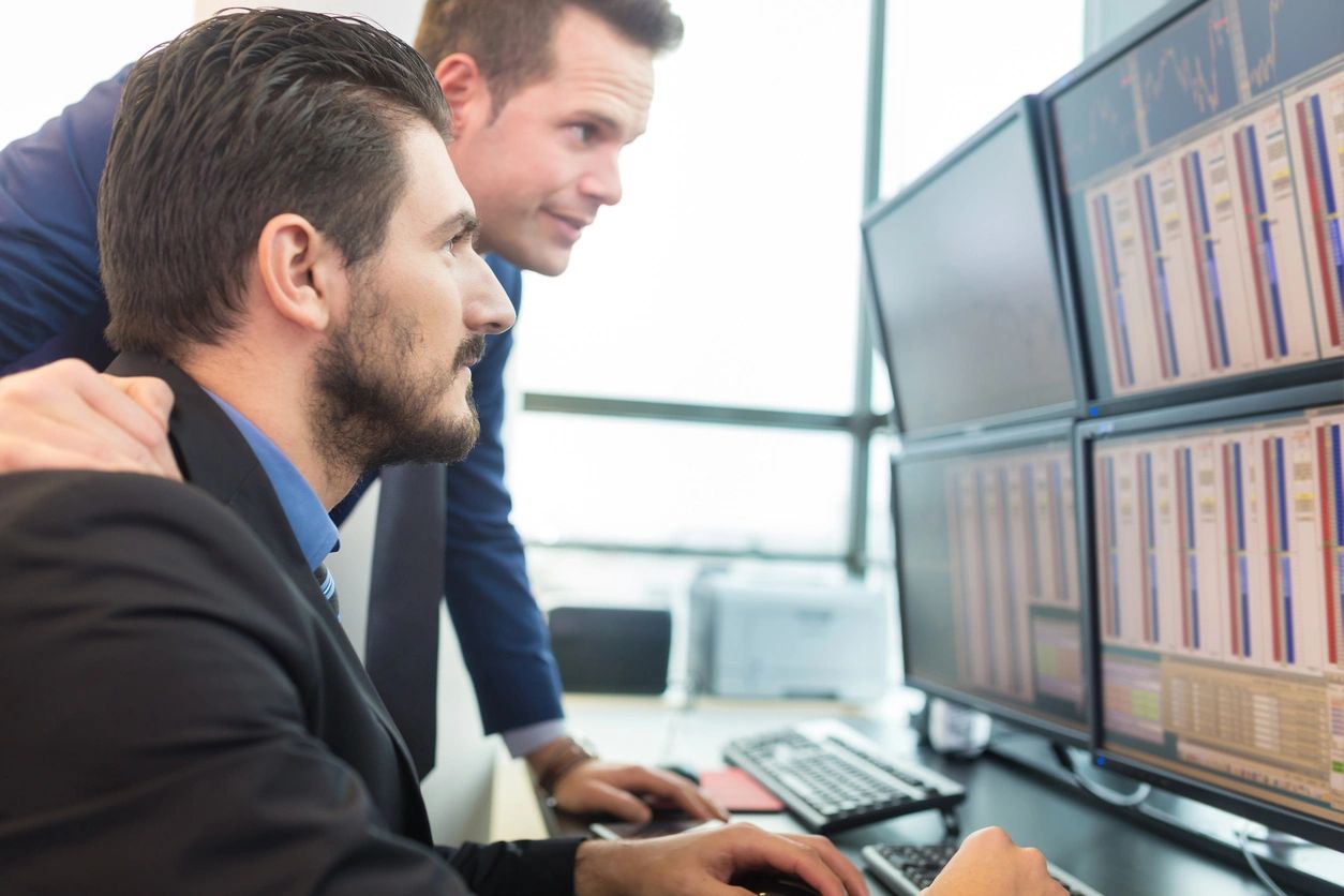 Marketing professional reviewing campaign data and analytics on a computer screen