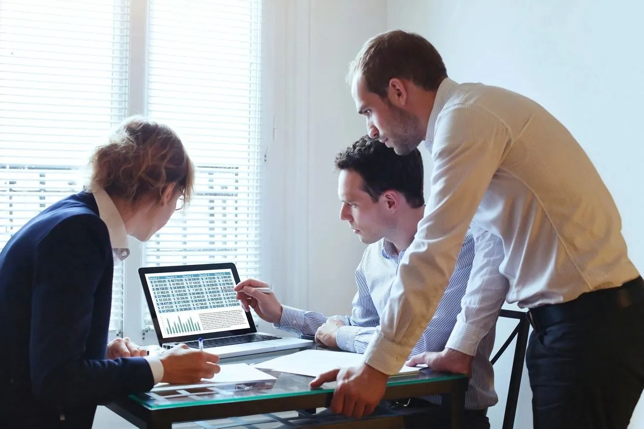 Marketing professionals reviewing insurance prospect data and campaign counts
