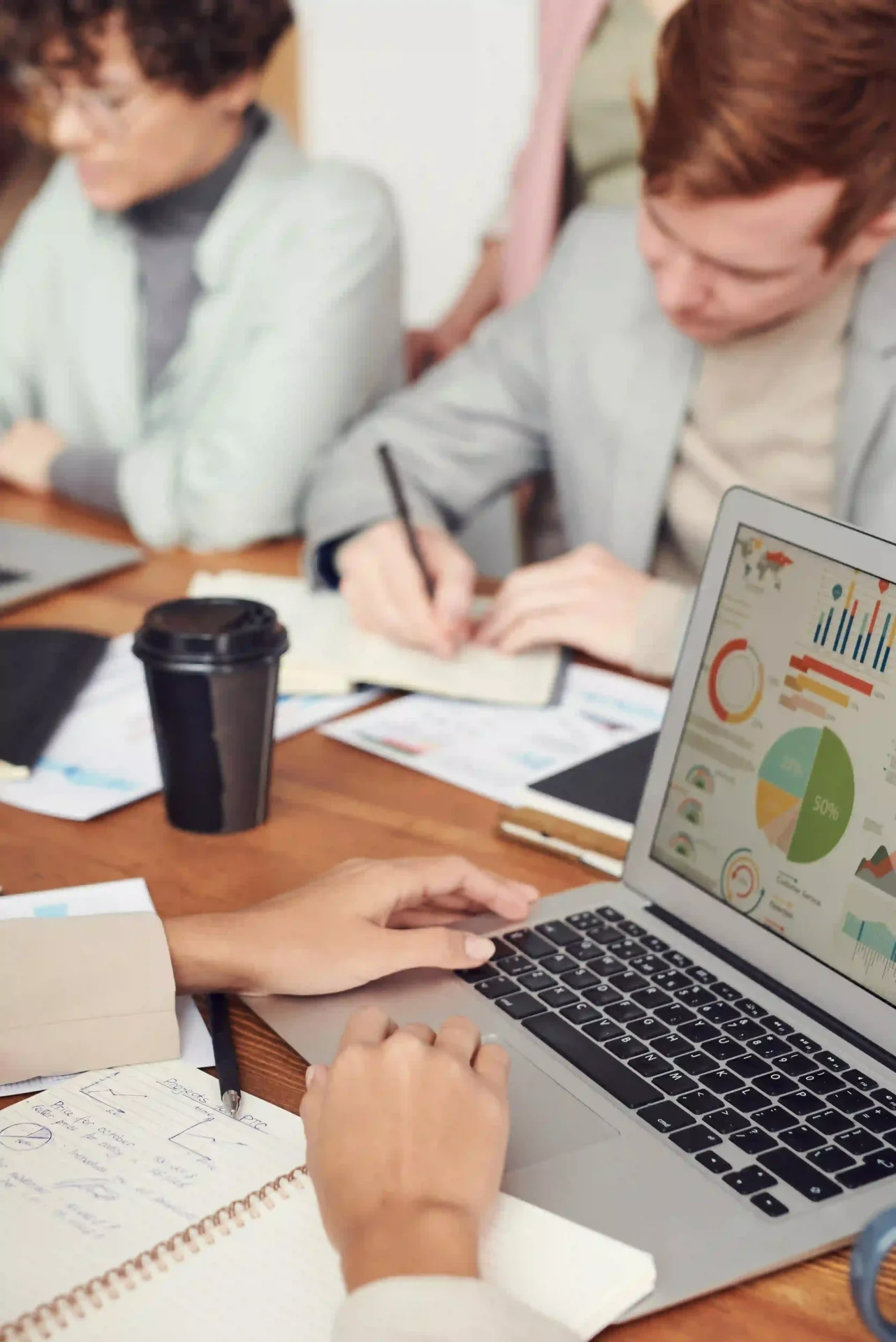 A team of data analysts and marketing strategists collaborating over performance reports